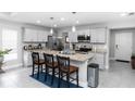 Bright, neutral kitchen featuring a spacious island, stainless steel appliances, and sleek cabinetry at 1857 E Cooper Dr, Deltona, FL 32725