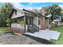 Charming home featuring a cozy front porch, brick chimney, and tasteful landscaping at 205 W Princeton St, Orlando, FL 32804