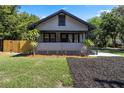 Charming home featuring a cozy front porch, manicured lawn, and tasteful landscaping at 205 W Princeton St, Orlando, FL 32804
