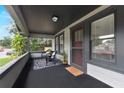 Inviting covered front porch with seating area, offering a relaxing outdoor space at 205 W Princeton St, Orlando, FL 32804