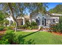 Inviting home exterior with mature trees and well-maintained landscaping at 215 Juniper Ridge Ct, Sanford, FL 32771