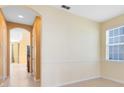 Hallway featuring tile flooring with neutral paint and an archway leading to the stairs at 2153 Cypress Villas Dr, Orlando, FL 32825