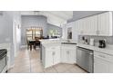 Bright kitchen features updated appliances and white cabinetry and flows into dining at 2511 Brookstone Dr, Kissimmee, FL 34744