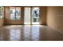 Bright living room featuring tile floors, lots of natural light and a sliding glass door to the balcony at 2524 Woodgate Blvd # 201, Orlando, FL 32822