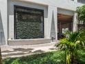 Modern building exterior with a decorative water feature and lush landscaping at 260 S Osceola Ave # 1207, Orlando, FL 32801