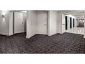 Modern hallway with patterned carpet, neutral walls, and unit entrances at 260 S Osceola Ave # 1207, Orlando, FL 32801