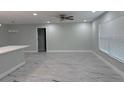Open-concept living area featuring a light gray walls and marble-style tile flooring at 2747 Rose Moss Ln, Orlando, FL 32807