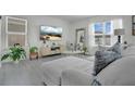 Open living area with chic decor, soft color palette and a view of the backyard at 2834 Common Crane Ct, St Cloud, FL 34773