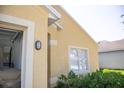 Close up on the exterior features neutral paint, a garage, and well-maintained landscaping at 30101 Pga Dr, Sorrento, FL 32776
