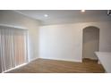 Bright living room with hardwood floors, neutral walls, and natural light from the sliding glass door at 30101 Pga Dr, Sorrento, FL 32776