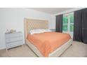 Comfortable bedroom featuring a king-size bed, neutral decor, and a bright window at 3479 Courtland Blvd, Deltona, FL 32738