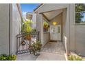 Inviting entryway with brick pavers, decorative gate, hanging light fixture, and plants creating a warm welcome at 3987 Lancashire Ln # 3987, Longwood, FL 32779
