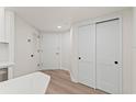 Hallway with modern sliding closet doors and light wood floors at 400 E Colonial Dr # 402, Orlando, FL 32803