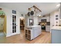 Charming kitchen with stainless appliances, kitchen island, and stylish pot rack at 4927 Fiske Cir, Orlando, FL 32826