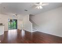 Bright and airy living room featuring beautiful wood floors and a staircase to the upper level at 6107 Metrowest Blvd # 104, Orlando, FL 32835