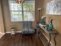 Stylish living space with a modern light fixture, elegant decor, and a large window providing natural light at 8417 Leeland Archer Blvd, Orlando, FL 32836