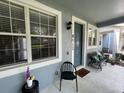 Inviting front porch featuring comfortable seating, creating a welcoming entrance to the home at 8417 Leeland Archer Blvd, Orlando, FL 32836