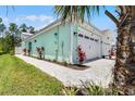 Charming home exterior featuring a well-kept lawn and a convenient two-car garage at 867 Bama Breeze Dr, Daytona Beach, FL 32124