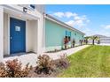 Bright home exterior with a welcoming blue front door and well-maintained landscaping at 867 Bama Breeze Dr, Daytona Beach, FL 32124