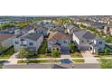 Well-maintained two-story home with a paved driveway leading to a two-car garage, surrounded by lush landscaping at 9038 Sunshine Ridge Loop, Kissimmee, FL 34747