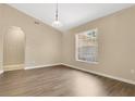 Inviting living room with a vaulted ceiling, natural light, and wood-look flooring at 922 Hatteras Ave, Minneola, FL 34715