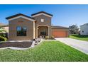 Charming single Gathering home with manicured lawn, neutral paint, and two-car garage at 997 La Mirada Ct, Kissimmee, FL 34744