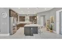 Spacious open kitchen featuring a large island, stainless steel appliances, and modern cabinetry at 13125 Alderley Dr, Orlando, FL 32832
