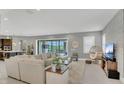 Open-concept living area with tile flooring, neutral tones, and sliding glass doors to outdoor space at 13125 Alderley Dr, Orlando, FL 32832