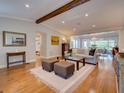 Bright and airy living room featuring hardwood floors, exposed beam, and an open floor plan at 1791 Spruce Ave, Winter Park, FL 32789