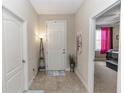 Inviting foyer with tile flooring, leading to various rooms, with a view of the bedroom at 20723 Macon Pkwy, Orlando, FL 32833