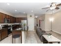 Open-concept kitchen with stainless steel appliances, granite counters, and a view into the living area at 20723 Macon Pkwy, Orlando, FL 32833