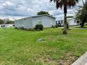 View of a light blue single-story home with a grassy front yard at 2711 Cranmoor Dr, Kissimmee, FL 34758