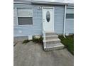 Close-up of the front door featuring three steps and a white railing at 2711 Cranmoor Dr, Kissimmee, FL 34758