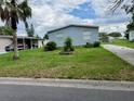 A well-maintained home with a long driveway and lawn at 2711 Cranmoor Dr, Kissimmee, FL 34758