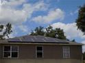 View of a roof with solar panels installed on a residential home at 2818 Sheila Dr, Apopka, FL 32712