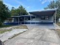 Charming single-story home featuring a covered carport and freshly painted in blue and grey at 2829 Sanford Ave, Sanford, FL 32773