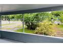 Covered porch area with serene views of the garden and street beyond at 2829 Sanford Ave, Sanford, FL 32773