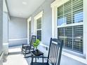Inviting front porch with rocking chairs, offering a relaxing outdoor seating area at 2943 Slough Creek Dr, Kissimmee, FL 34744