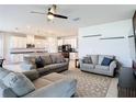 Bright and spacious living room featuring comfortable seating, a ceiling fan, and an open layout at 2943 Slough Creek Dr, Kissimmee, FL 34744