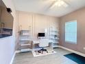 Stylish home office with a modern desk, shelving, and a large window at 2943 Slough Creek Dr, Kissimmee, FL 34744