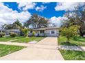 A single-story home with a well-manicured front yard and a concrete driveway at 3403 Canute Pl, Orlando, FL 32818