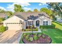Well-maintained single-story home showcasing manicured landscaping, an inviting entrance, and attached garage at 3499 Woodley Park Pl, Oviedo, FL 32765