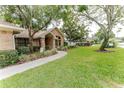 Well-maintained brick home with a landscaped yard and walkway leading to the front entrance at 356 Remington Dr, Oviedo, FL 32765