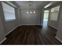Dining room featuring modern lighting, and large windows with hardwood floors leading to an adjacent sitting room at 3707 Andover Cay Blvd, Orlando, FL 32825