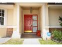Welcoming front door with sidelights, an overhead light, and a small bench creating an inviting entrance at 4035 Palo Alto Ct, Orlando, FL 32817