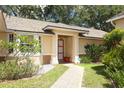 Inviting front entrance features a red door, neutral-colored exterior, and walkway leading to a welcoming home at 4035 Palo Alto Ct, Orlando, FL 32817