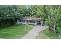 Overhead view of charming single-story home with a brick driveway and lush landscaping at 409 E Gulley Ave, Oakland, FL 34760