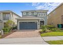 Charming home with a two-car garage and a lovely brick paved driveway, surrounded by mature landscaping at 441 Novi Path, Kissimmee, FL 34747