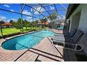 Screened-in pool with a brick deck and lounge chairs, perfect for relaxation at 446 Summer Place Loop, Clermont, FL 34714