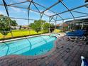 Relaxing screened-in pool and patio area, featuring comfortable lounge chairs for ultimate leisure at 446 Summer Place Loop, Clermont, FL 34714